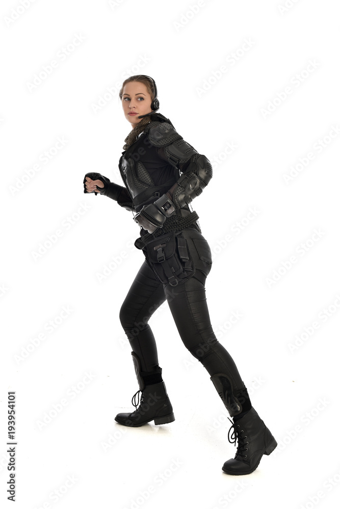 full length portrait of female soldier wearing black tactical armour, isolated on white studio background. full length portrait of female soldier wearing black tactical armour, isolated on white studio background.