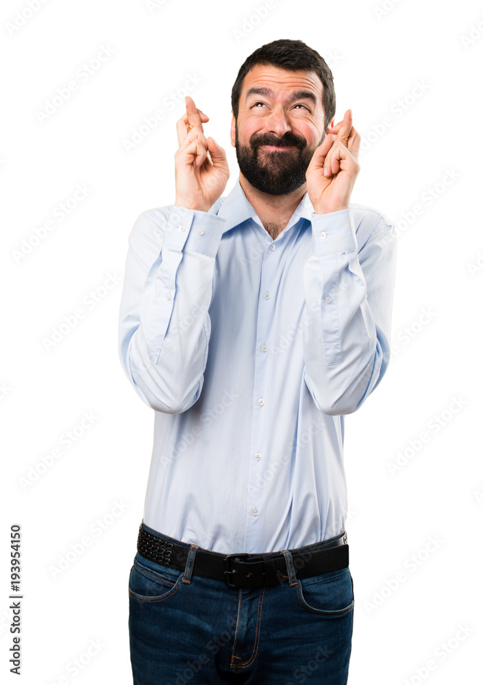 Handsome man with beard with his fingers crossing Handsome man with beard with his fingers crossing