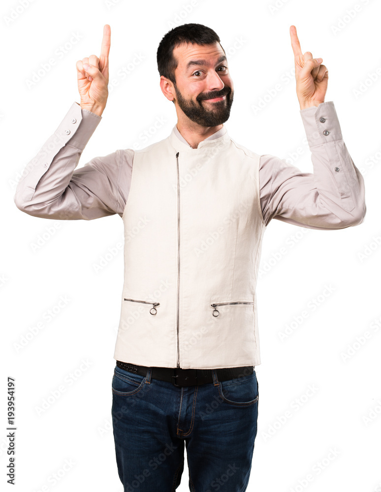 Handsome man with vest pointing up on isolated white background