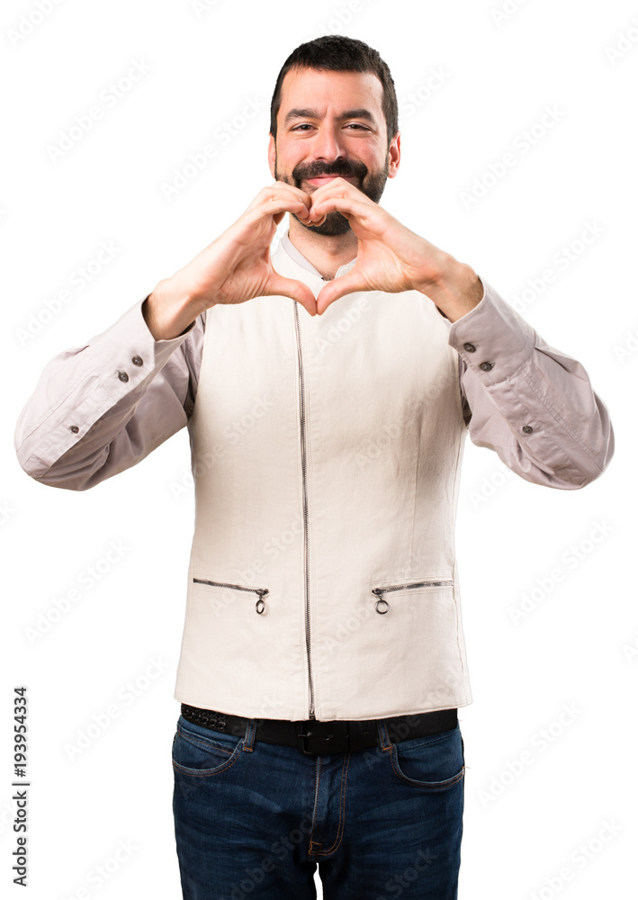 Handsome man with vest making a heart with his hands on isolated white background Handsome man with vest making a heart with his hands on isolated white background