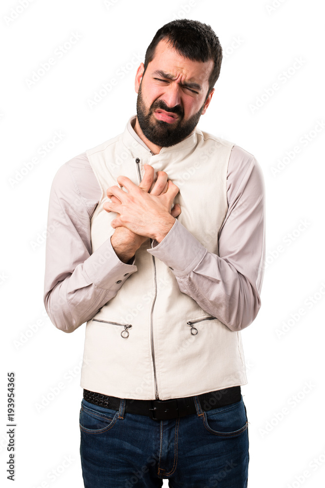 Handsome man with vest with heart pain on isolated white background Handsome man with vest with heart pain on isolated white background