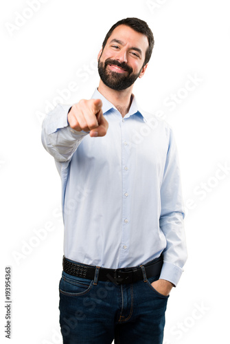 Handsome man with beard pointing to the front