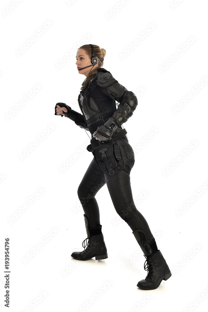 full length portrait of female soldier wearing black tactical armour, isolated on white studio background. full length portrait of female soldier wearing black tactical armour, isolated on white studio background.