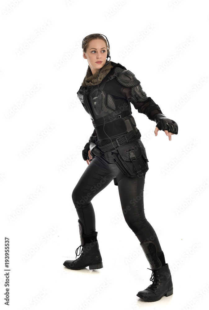 full length portrait of female soldier wearing black tactical armour, isolated on white studio background. full length portrait of female soldier wearing black tactical armour, isolated on white studio background.