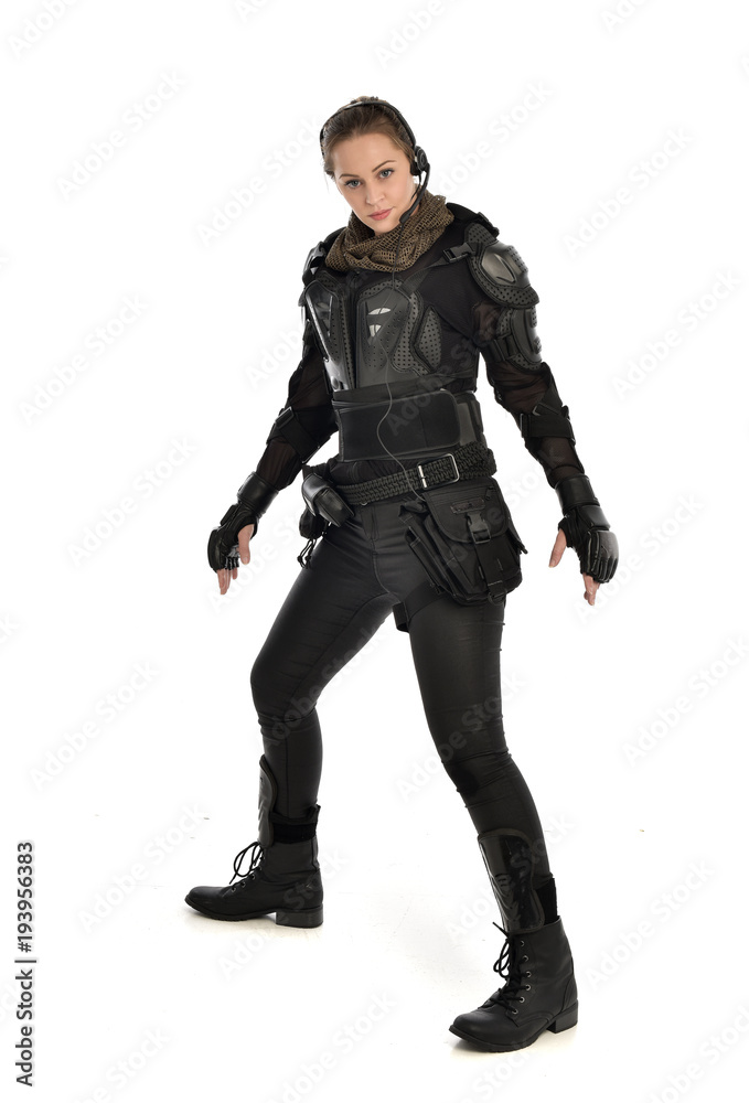 full length portrait of female soldier wearing black tactical armour, isolated on white studio background. full length portrait of female soldier wearing black tactical armour, isolated on white studio background.