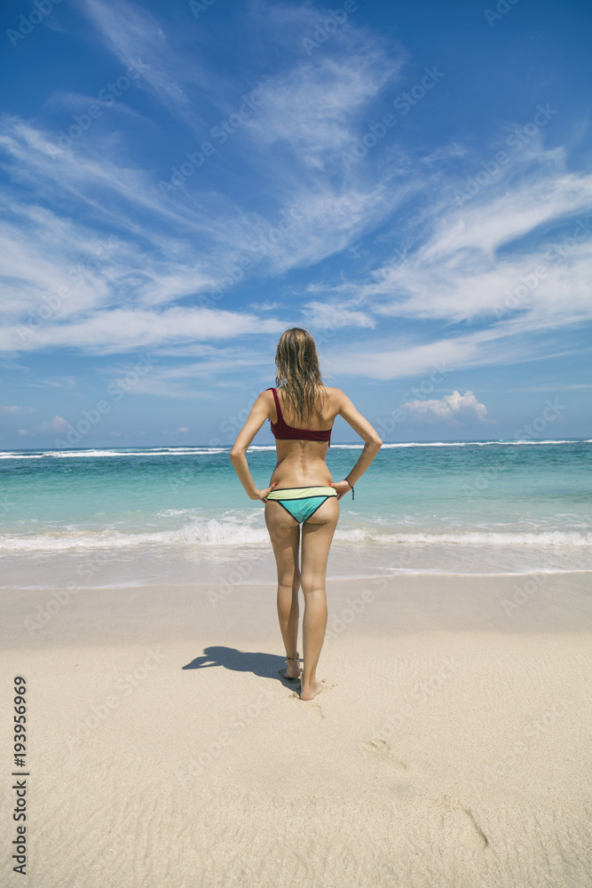 Beautiful woman in bikini enjoying on the beach. Summer concept.