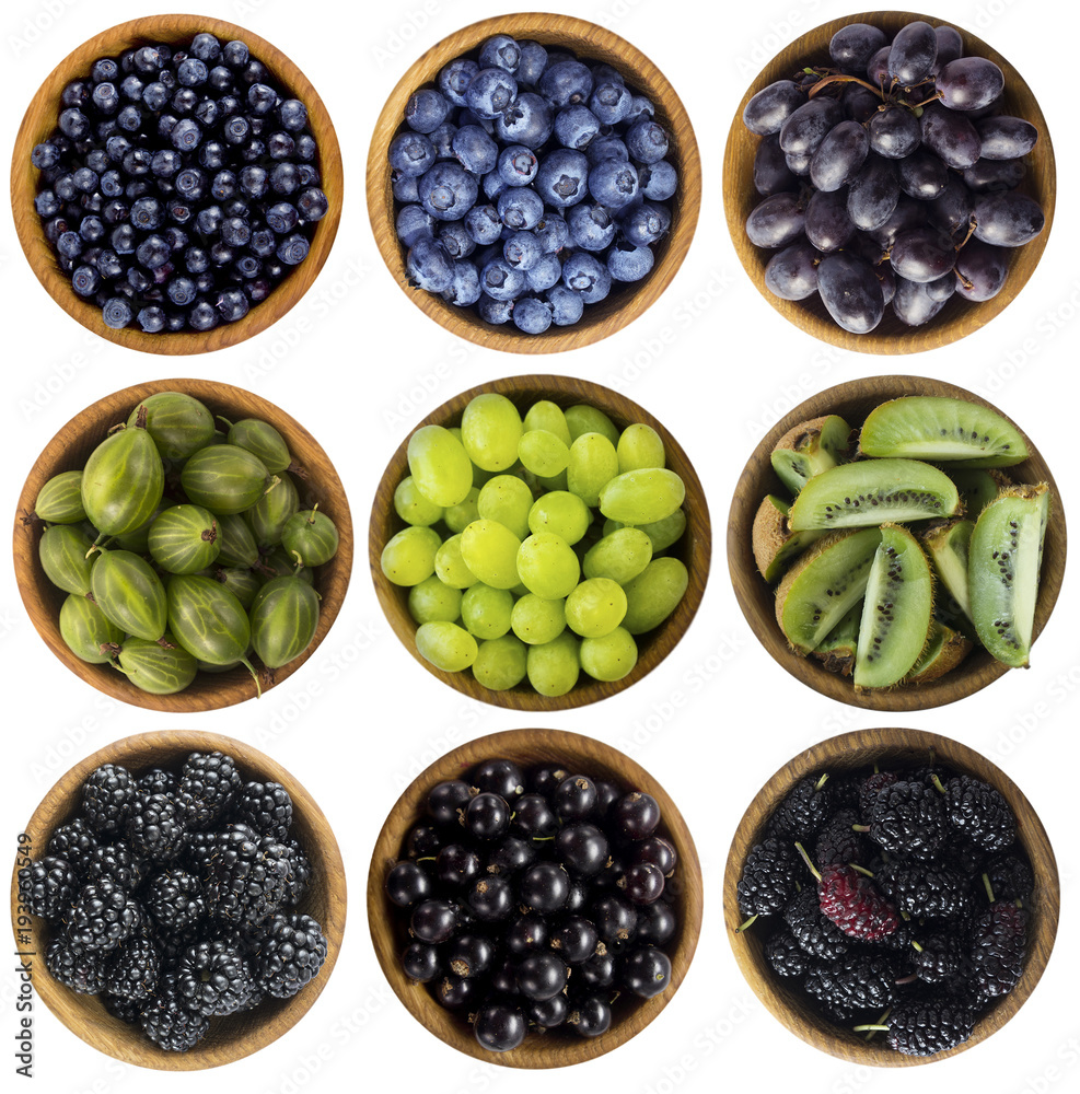 Blue-black and green food. Berries and fruits isolated on white background.  Collage of different fruits and berries at green and blue-black color. Top  view. Various fresh summer on white background. Photos