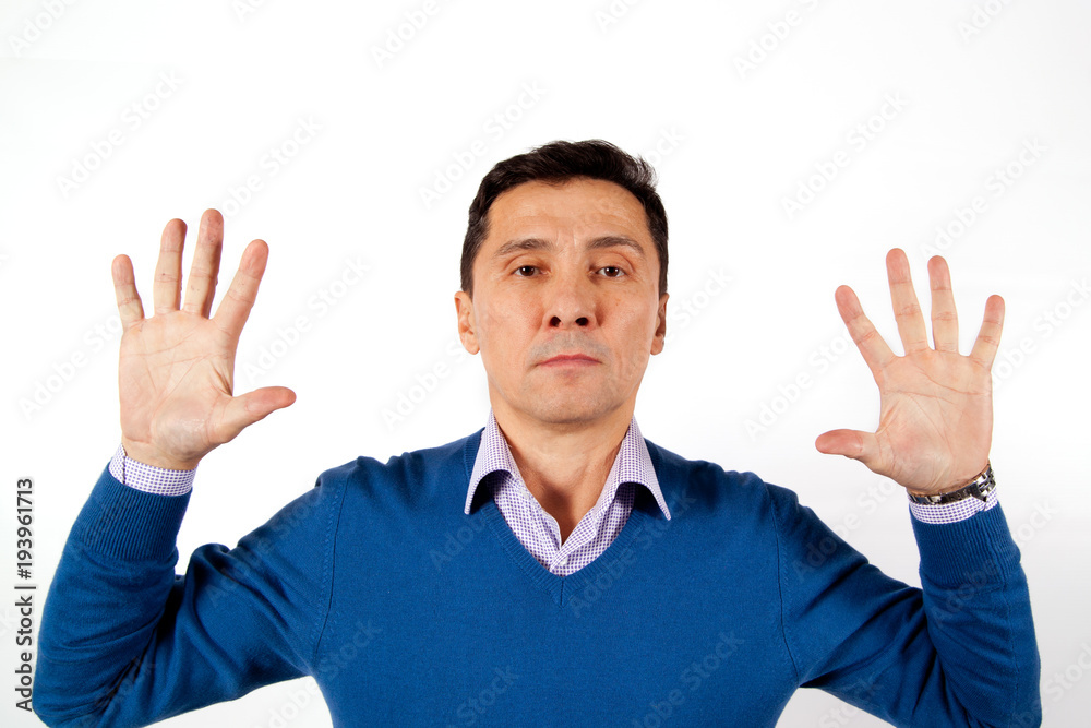 Portrait of a serious adult men dressed in blue sweater with their hands up Portrait of a serious adult men dressed in blue sweater with their hands up