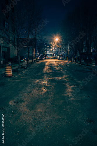 Dark empty and scary urban city street.road with alleys under construction at night