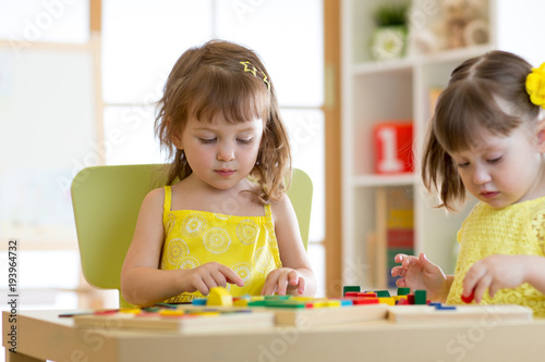 Kids play educational toys in kindergarten or daycare