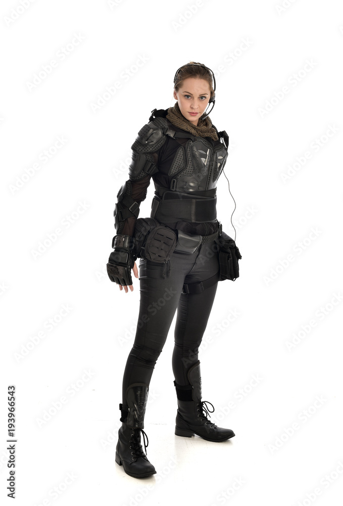 full length portrait of female soldier wearing black tactical armour, isolated on white studio background. full length portrait of female soldier wearing black tactical armour, isolated on white studio background.