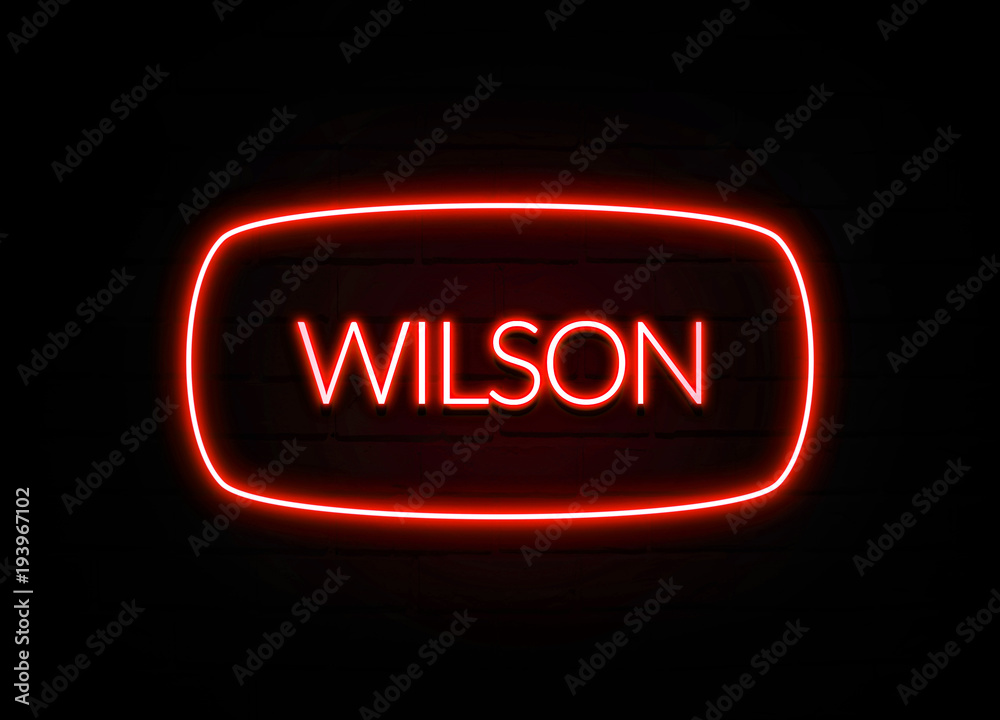 Wilson neon sign on brick wall background. Wilson neon sign on brick wall background.