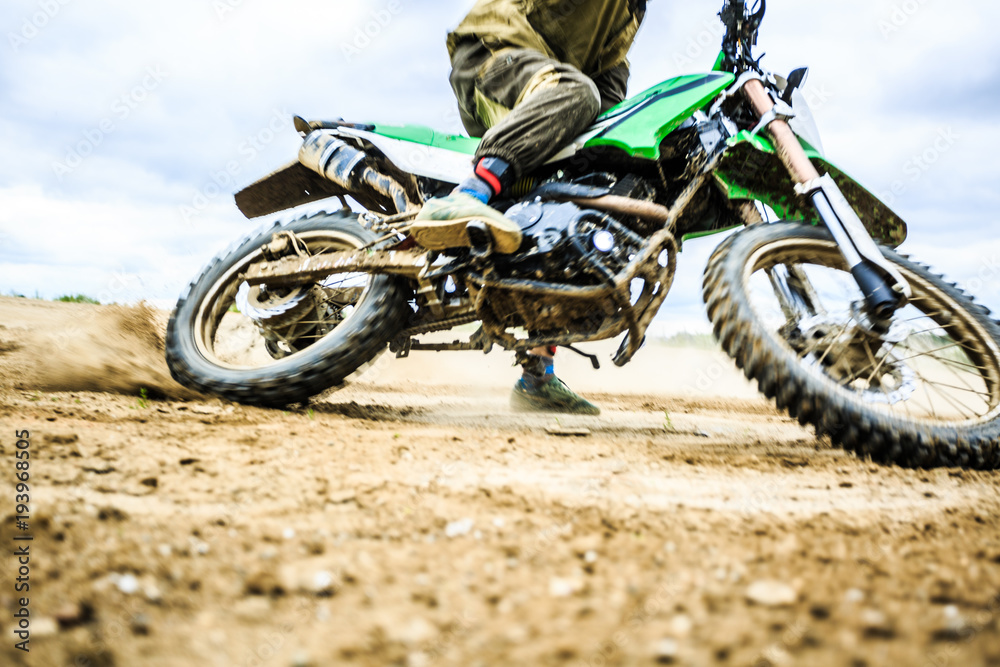 Close-up of mountain motocross race in dirt track in day time. Close-up of mountain motocross race in dirt track in day time.