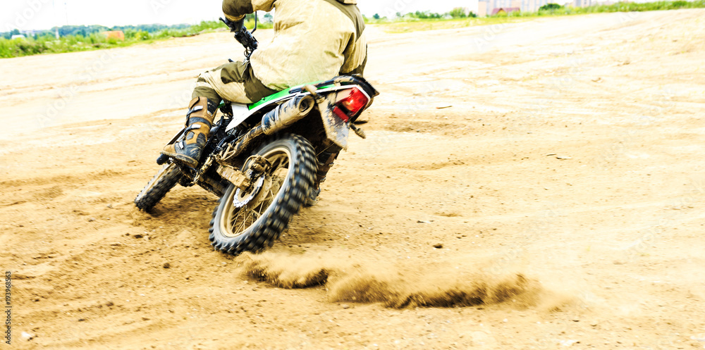 Close-up of mountain motocross race in dirt track in day time. Close-up of mountain motocross race in dirt track in day time.