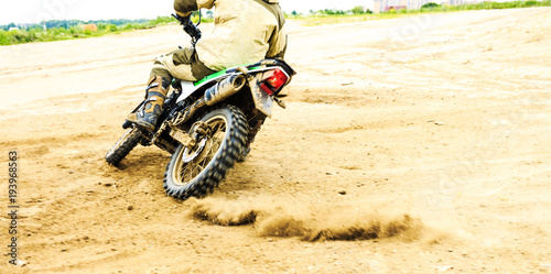 Close-up of mountain motocross race in dirt track in day time.