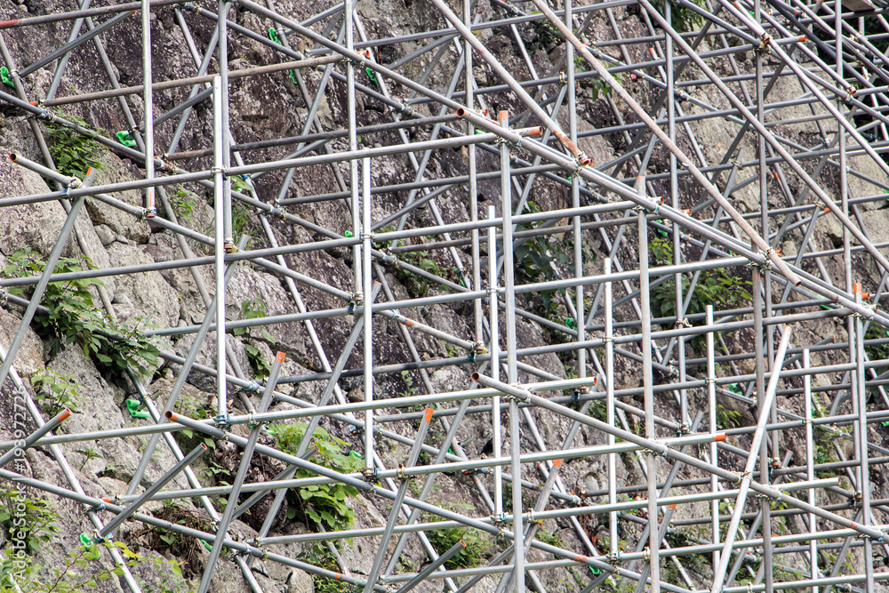 Construction of a stone wall. Steel scaffolding built on the stone walls of the fort. Reconstruction of the monument. Construction of a stone wall. Steel scaffolding built on the stone walls of the fort. Reconstruction of the monument.
