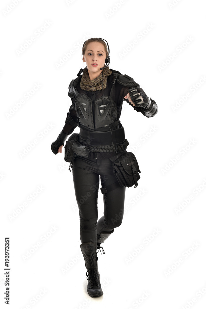 full length portrait of female soldier wearing black tactical armour, isolated on white studio background. full length portrait of female soldier wearing black tactical armour, isolated on white studio background.