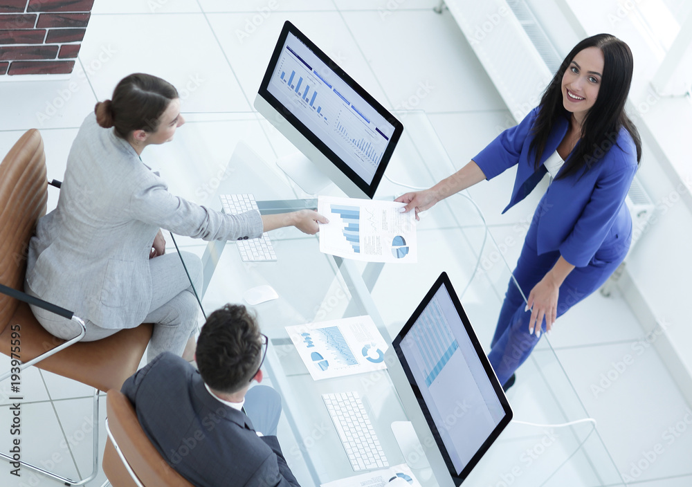 A satisfied business lady explains the statistics chart A satisfied business lady explains the statistics chart