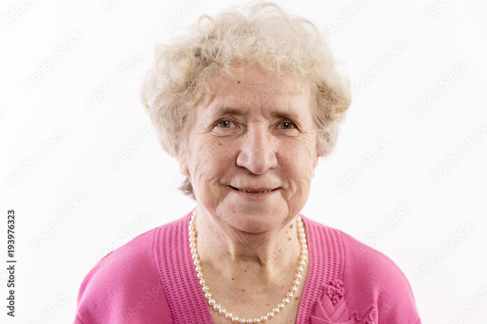 An elderly woman with gray curly hair laughs An elderly woman with gray curly hair laughs