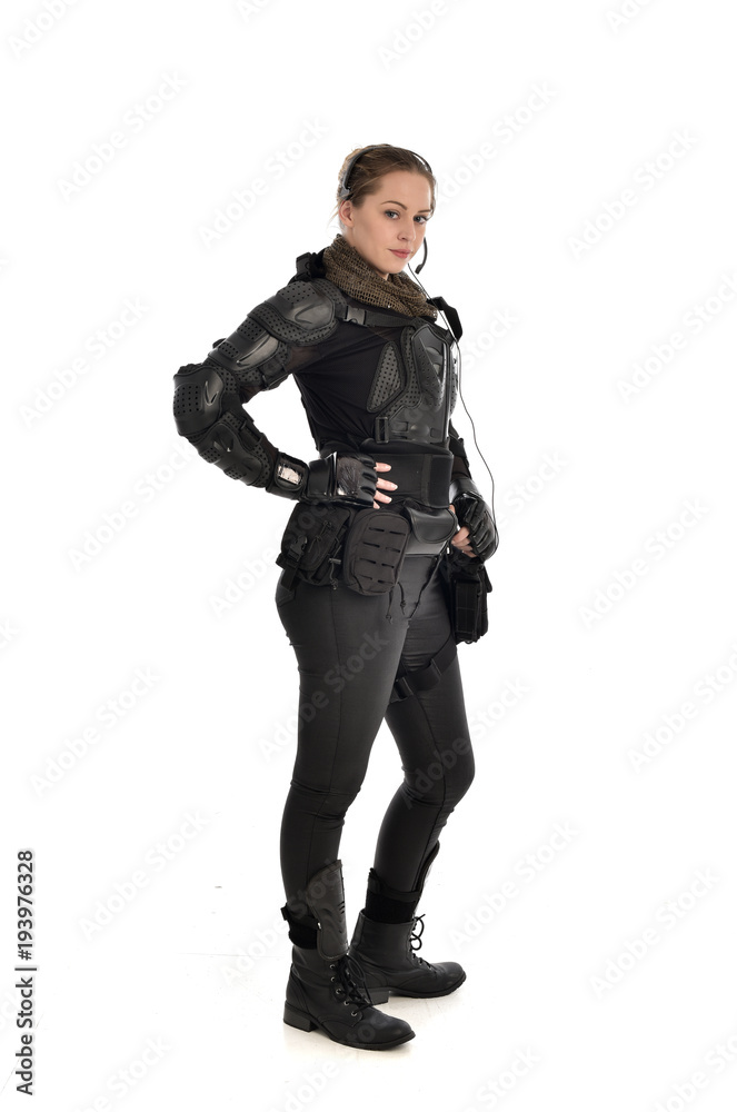 full length portrait of female soldier wearing black tactical armour, isolated on white studio background. full length portrait of female soldier wearing black tactical armour, isolated on white studio background.