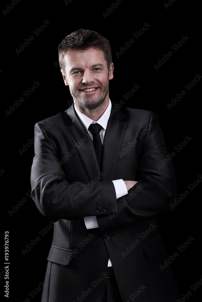 Happy business man arms folded isolated on black. Happy business man arms folded isolated on black.