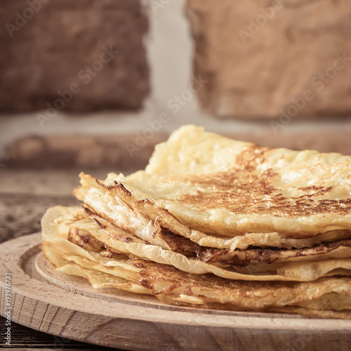 Pancakes in stack on wooden board close-up  Food concept holiday