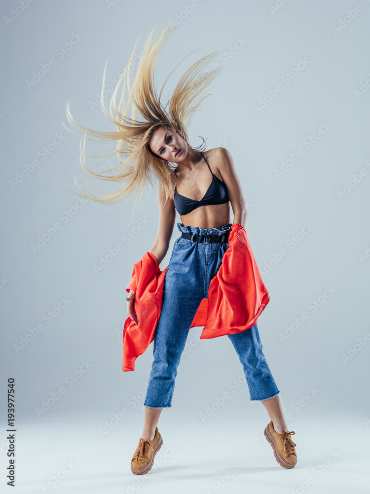 Young beautiful female dancer is posing in the studio Young beautiful female dancer is posing in the studio