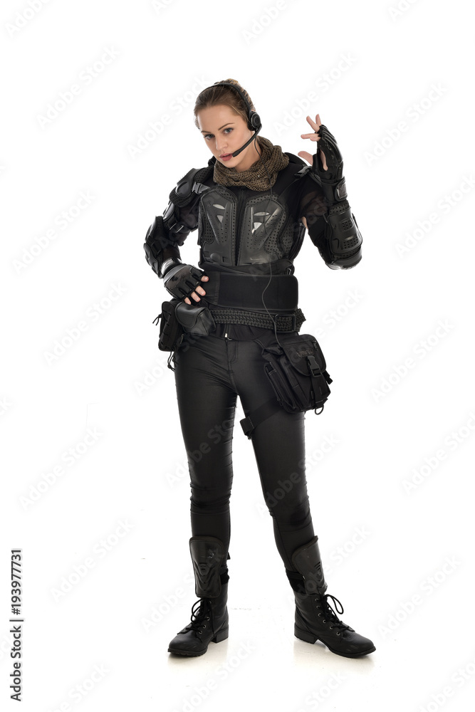 full length portrait of female soldier wearing black tactical armour, isolated on white studio background. full length portrait of female soldier wearing black tactical armour, isolated on white studio background.