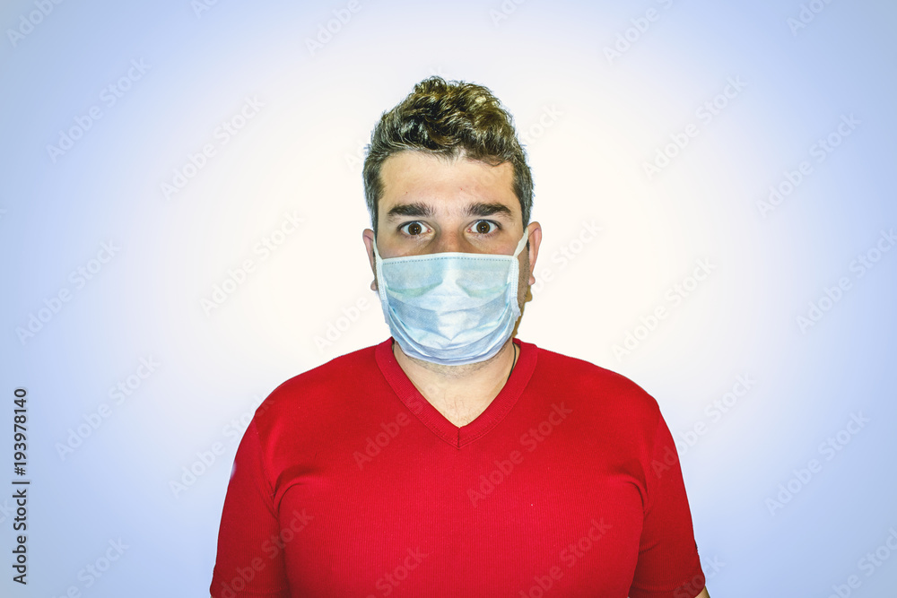 Handsome man Photo of healthy man wears protective mask against infectious diseases and flu. Health care concept. flue and influenza concept Handsome man Photo of healthy man wears protective mask against infectious diseases and flu. Health care concept. flue and influenza concept