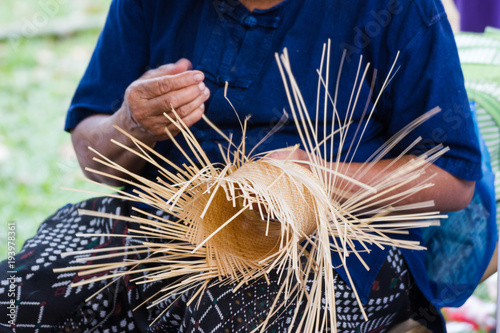 The villagers took bamboo stripes to weave into different forms for daily use utensils of the community’s people in Bangkok Thailand, Thai handmade product.   photo