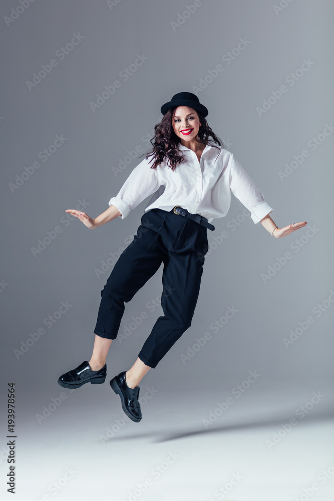 Young beautiful female dancer is posing in the studio Young beautiful female dancer is posing in the studio
