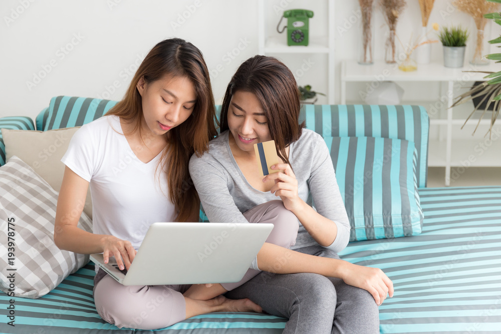 Asian woman couple are happy shopping online on sofa,The concept of a new  generation online purchase Stock Photo | Adobe Stock