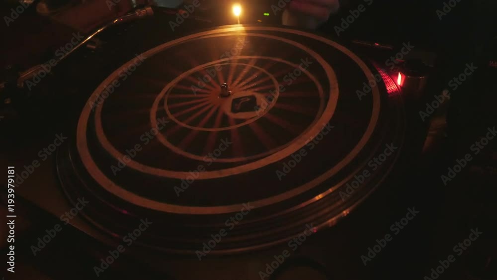cool dj behind the turntables performing in a bar cool dj behind the turntables performing in a bar