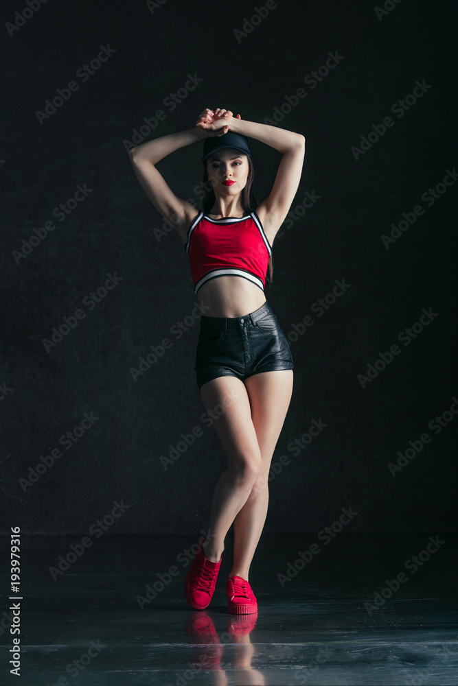 Young beautiful female dancer is posing in the studio Young beautiful female dancer is posing in the studio