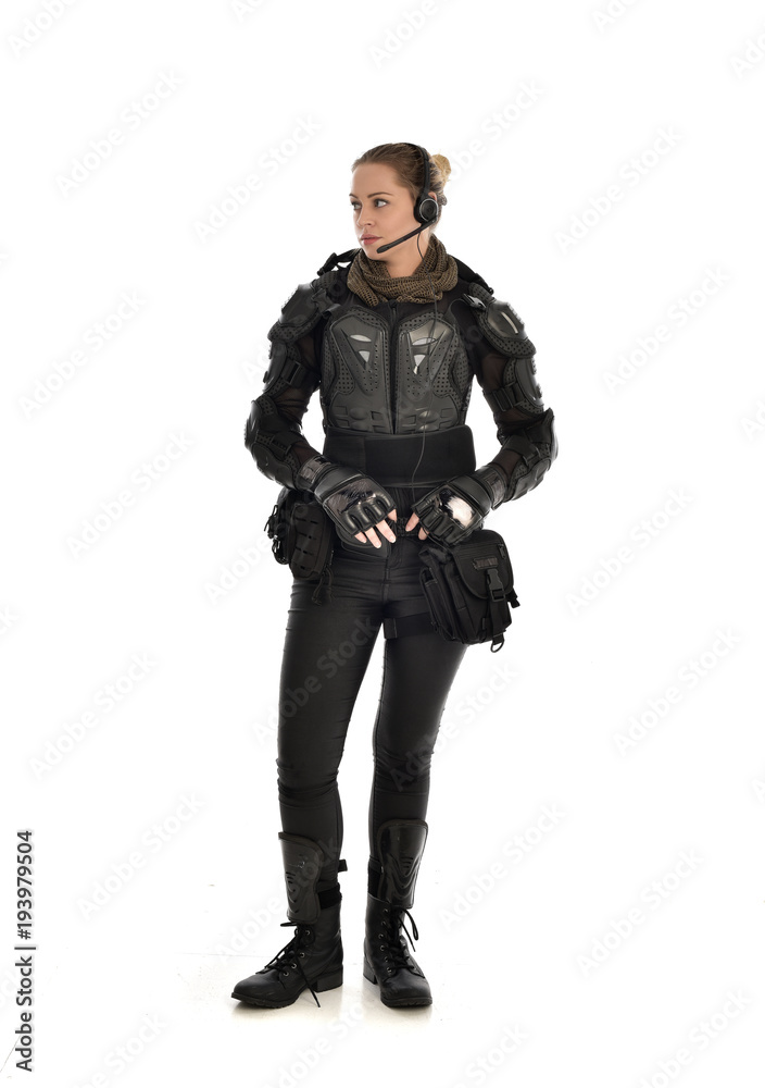 full length portrait of female soldier wearing black tactical armour, isolated on white studio background. full length portrait of female soldier wearing black tactical armour, isolated on white studio background.
