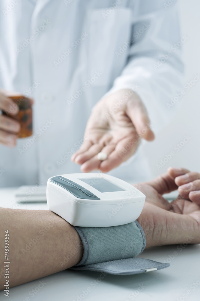Fototapeta premium doctor measuring the blood pressure of a patient