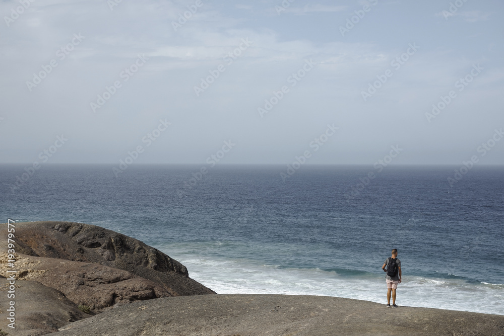 man observing the ocean in Fuerteventura, Spain