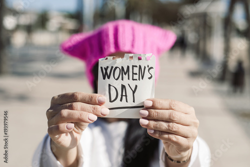 woman with a pink hat and the text womens day photo