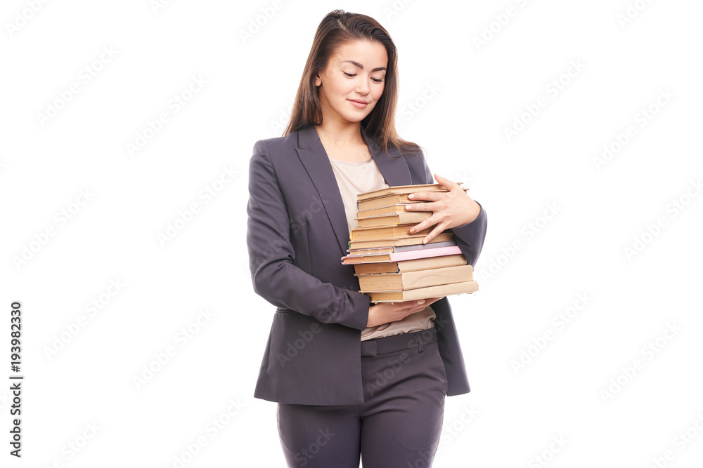 Portrait of young businesswoman holding stack of books Portrait of young businesswoman holding stack of books