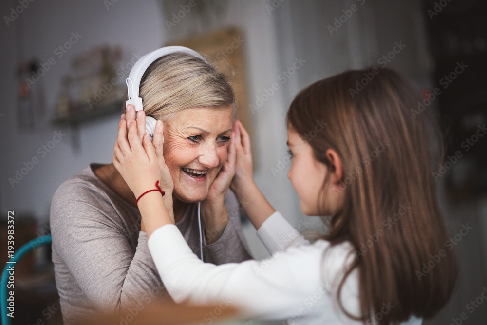 A small girl and grandmother with smartphone at home. A small girl and grandmother with smartphone at home.