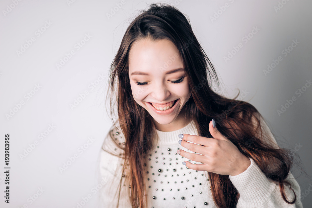 Beautiful woman laughing, smiling on a white background. emotions, expressive facial features. Beautiful woman laughing, smiling on a white background. emotions, expressive facial features.