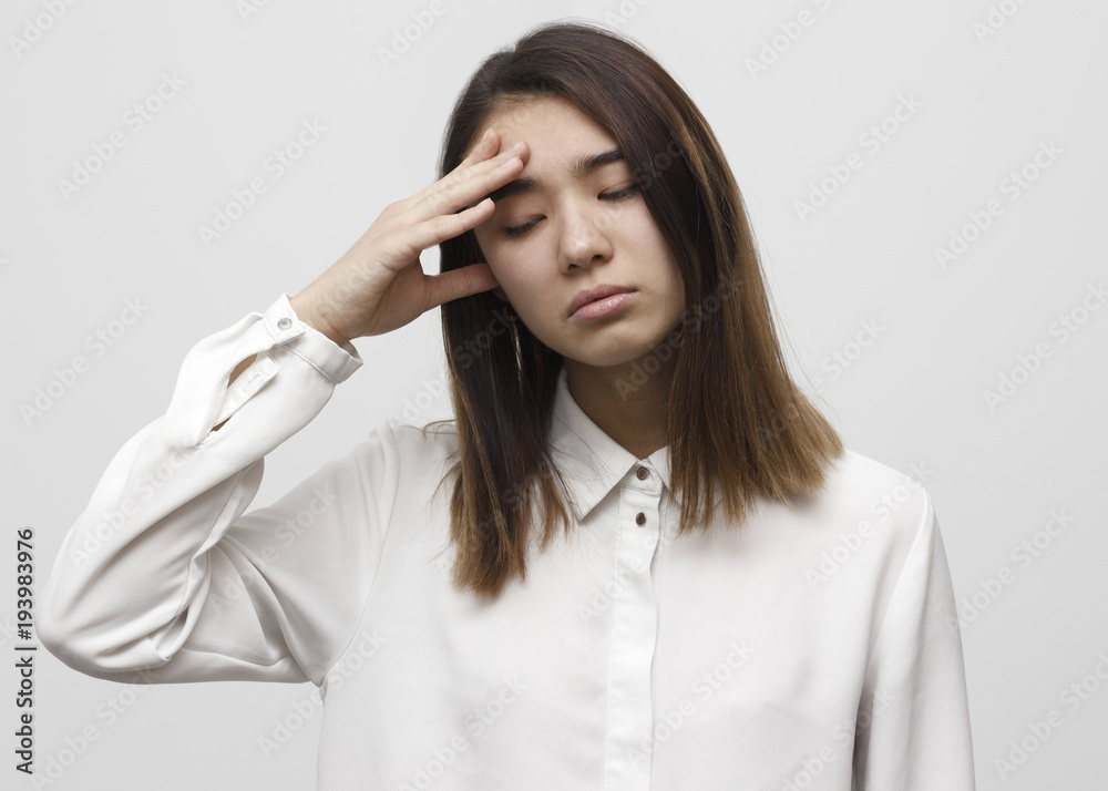 Portrait of beautiful young brunette touching her head feeling stress. Headache concept Portrait of beautiful young brunette touching her head feeling stress. Headache concept