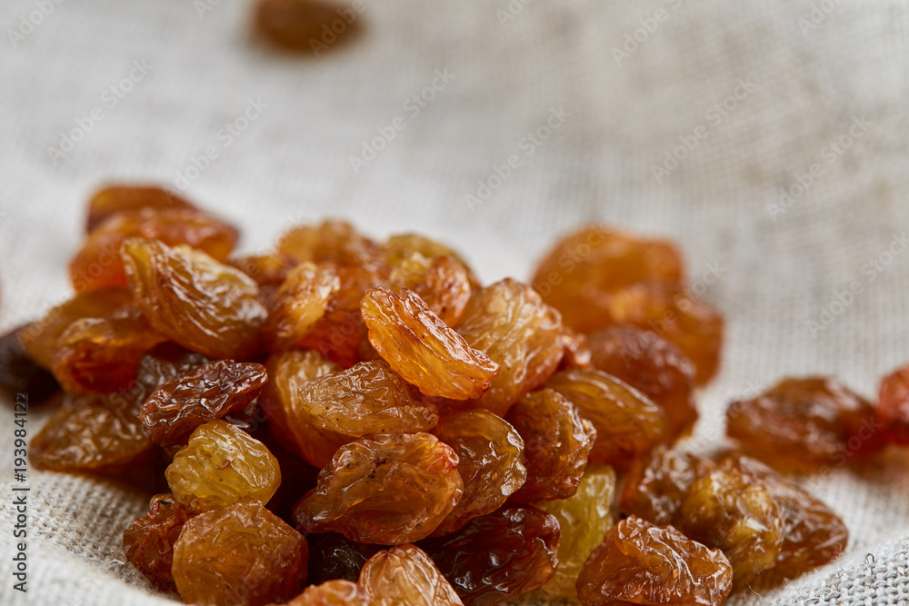 Dried raisins isolated on white background, close-up, macro, shallow depth of field, back light Dried raisins isolated on white background, close-up, macro, shallow depth of field, back light