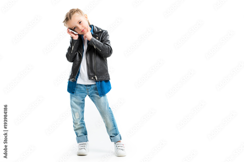 View of kid talking on smartphone and holding finger on chin isolated on white View of kid talking on smartphone and holding finger on chin isolated on white