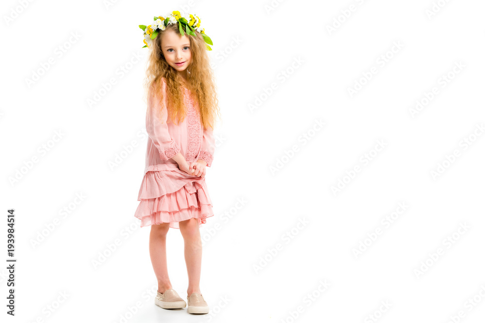 Child in pink dress wearing wreath band from flowers isolated on white Child in pink dress wearing wreath band from flowers isolated on white
