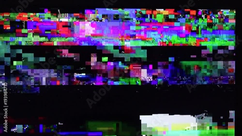 Digital TV glitch on television screen with misplaced squares, static effects and freezing problems during broadcast failure