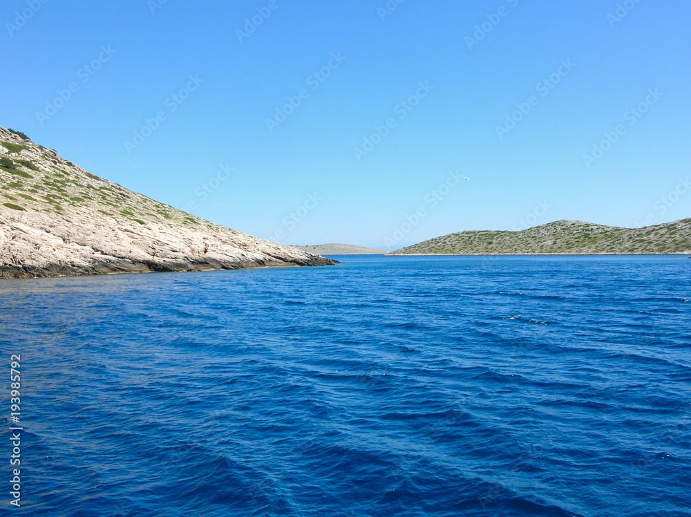 Sea surface aerial view. Background shot of clear sea water surface. Blue sea water in calm. Sea texture. Background blue waves.