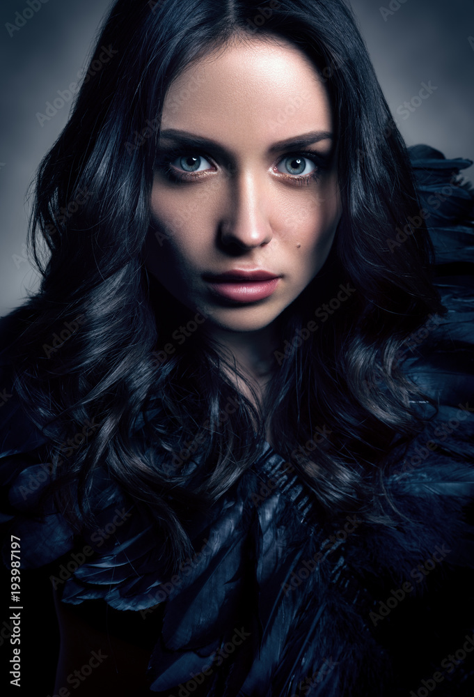 Vertical toned fashion portrait in dark tones. Beautiful young woman in black Vertical toned fashion portrait in dark tones. Beautiful young woman in black