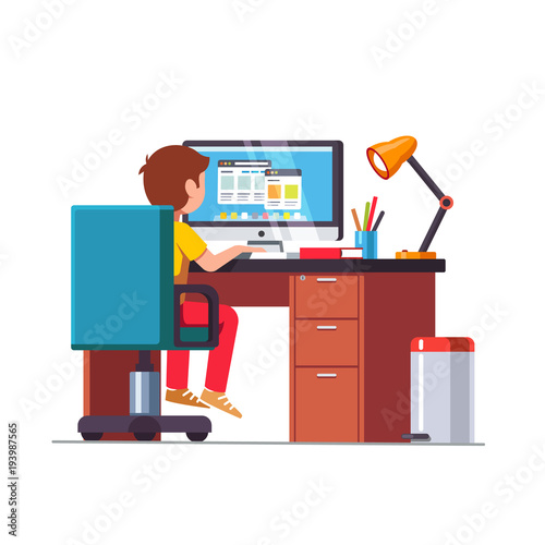 Student boy sitting at desk, doing school homework