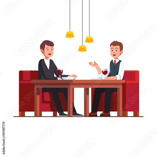 Two business man eating lunch at restaurant